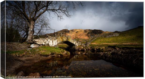 Moody Slaters bridge in the lake district Cumbria between rain and sleet showers.   517  Canvas Print by PHILIP CHALK