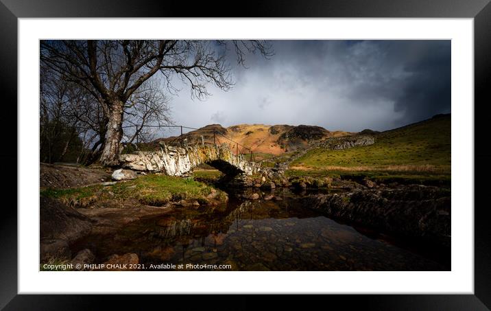 Moody Slaters bridge in the lake district Cumbria between rain and sleet showers.   517  Framed Mounted Print by PHILIP CHALK