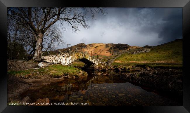 Moody Slaters bridge in the lake district Cumbria between rain and sleet showers.   517  Framed Print by PHILIP CHALK