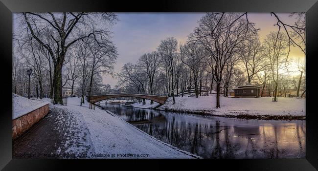 Sunset in snowy city park Framed Print by Maria Vonotna