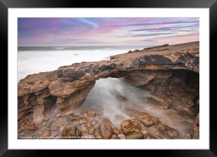 Arch shaped rock formation in the coastline at the sunset Framed Mounted Print by nuno valadas