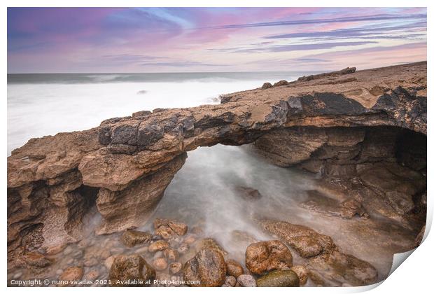 Arch shaped rock formation in the coastline at the sunset Print by nuno valadas