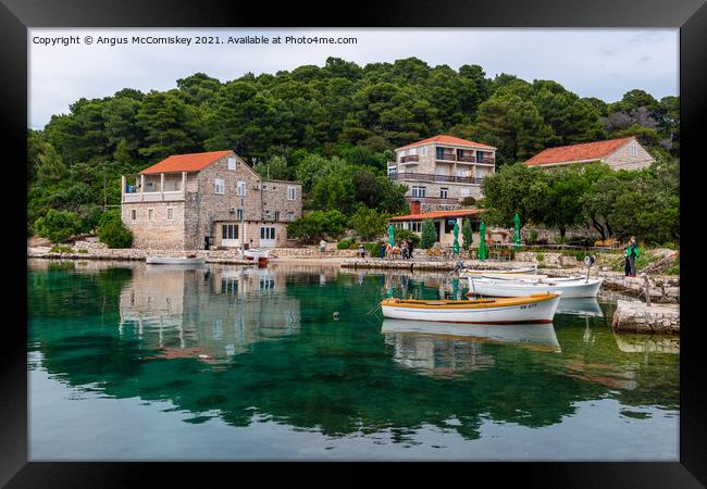 Colourful reflections in Pomena harbour, Croatia Framed Print by Angus McComiskey
