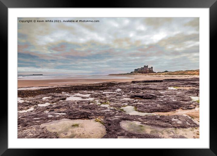 Bamburgh Castle under stormy sky Framed Mounted Print by Kevin White