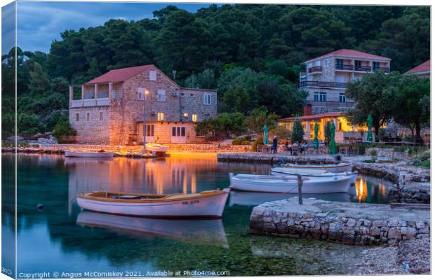 Boats tied up in Pomena harbour at dusk, Croatia Canvas Print by Angus McComiskey