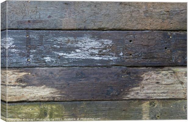 Abstract background of damp stacked wooden railway sleepers covered with frost Canvas Print by SnapT Photography