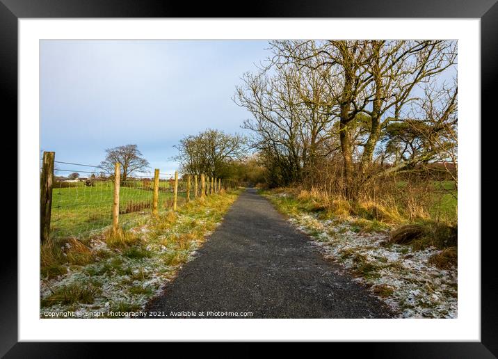 A frosty countryside trail, with snow on the ground, Scotland Framed Mounted Print by SnapT Photography