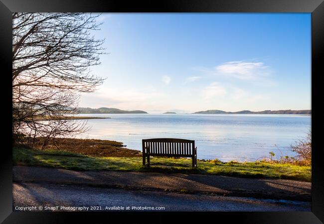 An empty wooden seat or bench over looking the sea at Kirkcudbright Bay Framed Print by SnapT Photography