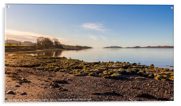 Sunrise on a rocky beach at Kirkcudbright Bay, Dumfries and Galloway, Scotland Acrylic by SnapT Photography