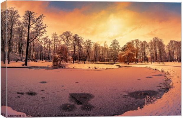 Sunset over winter park with small frozen lake Canvas Print by Maria Vonotna