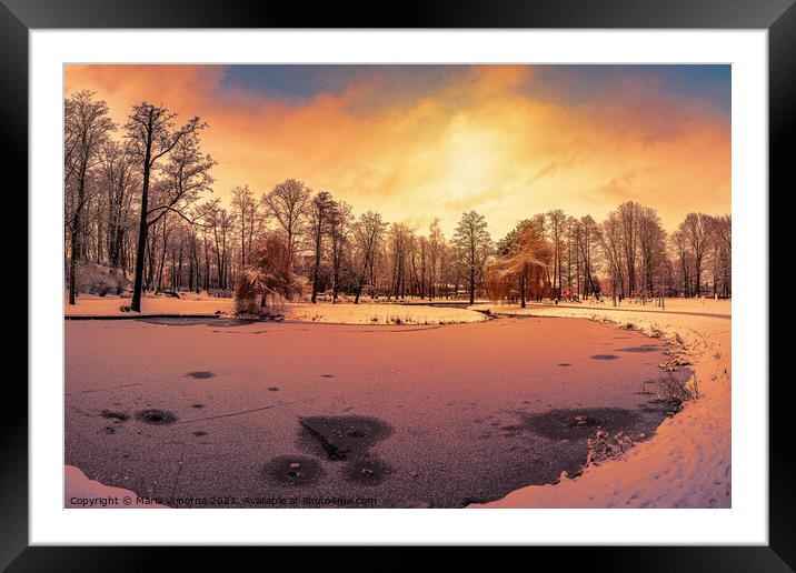 Sunset over winter park with small frozen lake Framed Mounted Print by Maria Vonotna