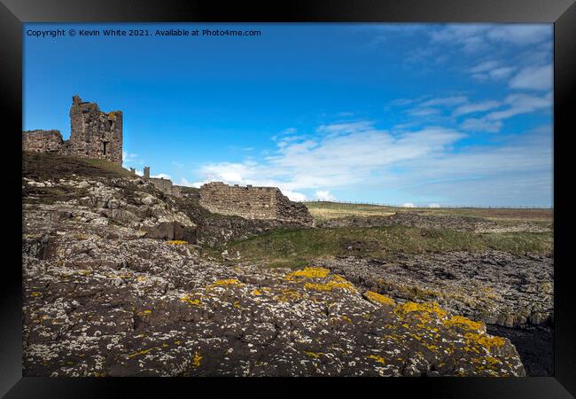 Dunstanburgh castle from St Margarets bay Framed Print by Kevin White