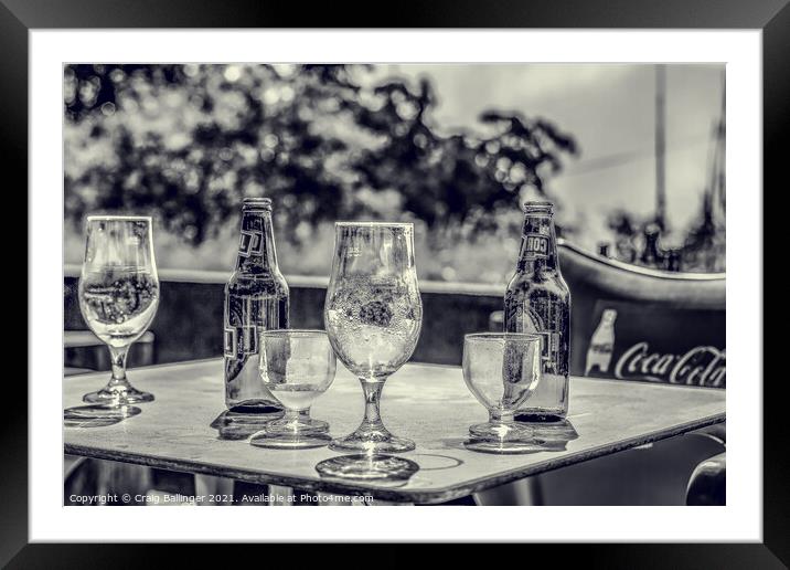 Beer bottles and glasses after an afternoon drinki Framed Mounted Print by Craig Ballinger