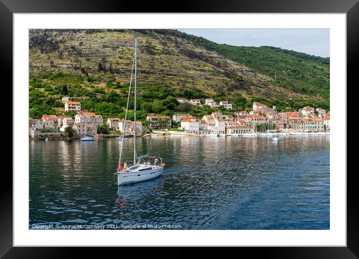 Yacht departing Vis Island, Croatia Framed Mounted Print by Angus McComiskey