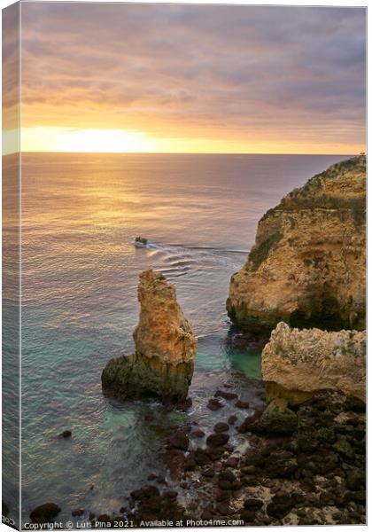 Ponta da Piedade and a boat in Lagos at sunrise, in Portugal Canvas Print by Luis Pina