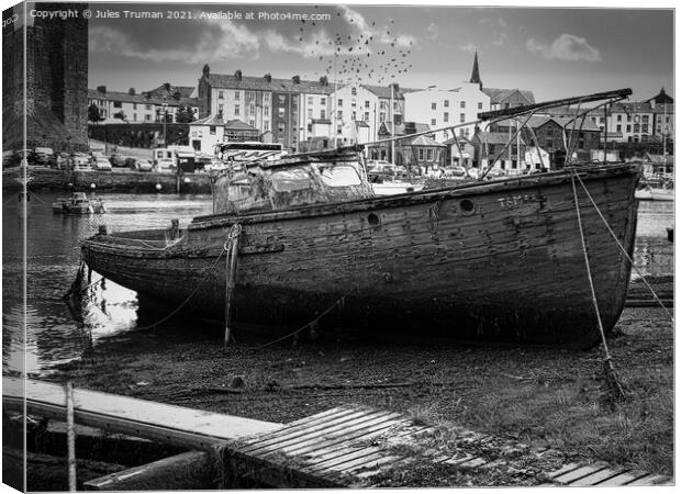 Wrecked old boat opposite Caernarfon Castle Canvas Print by Jules D Truman