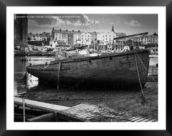 Wrecked old boat opposite Caernarfon Castle Framed Mounted Print by Jules D Truman
