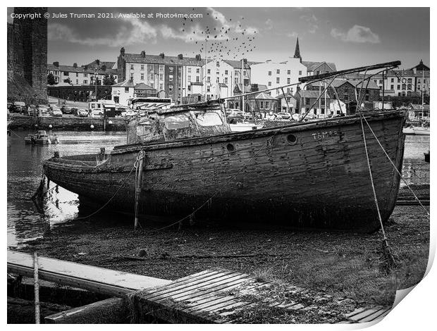 Wrecked old boat opposite Caernarfon Castle Print by Jules D Truman