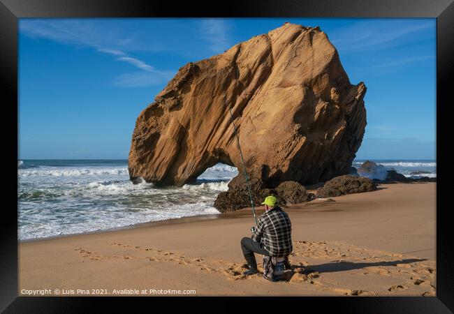 Fisherman in Praia de Santa Cruz beach rock boulder, Portugal Framed Print by Luis Pina