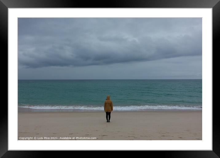 Woman girl with yellow jacket on an empty beach with stormy weather and turquoise water Framed Mounted Print by Luis Pina