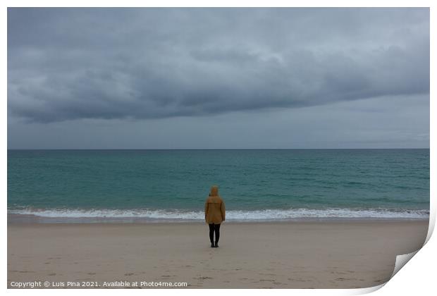 Woman girl with yellow jacket on an empty beach with stormy weather and turquoise water Print by Luis Pina