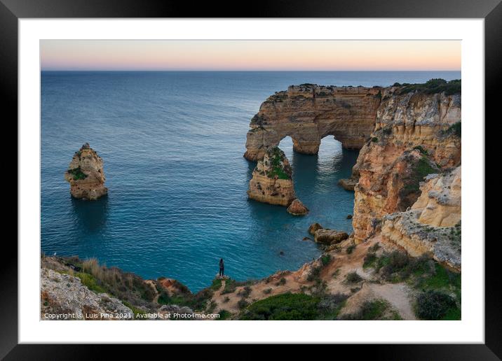 Woman girl in Natural arch cliffs of Praia da Marinha beach at sunset beautiful landscape with atlantic ocean, in Lagoa Portugal Framed Mounted Print by Luis Pina