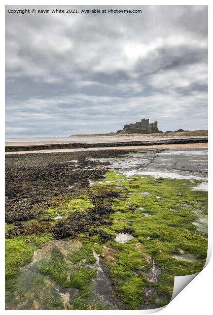 Bamburgh Castle at low tide Print by Kevin White
