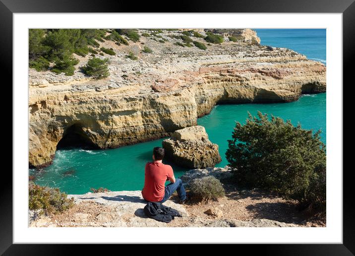 Man looking at a wild hidden secret beach with amazing turquoise water in Algarve, Portugal Framed Mounted Print by Luis Pina