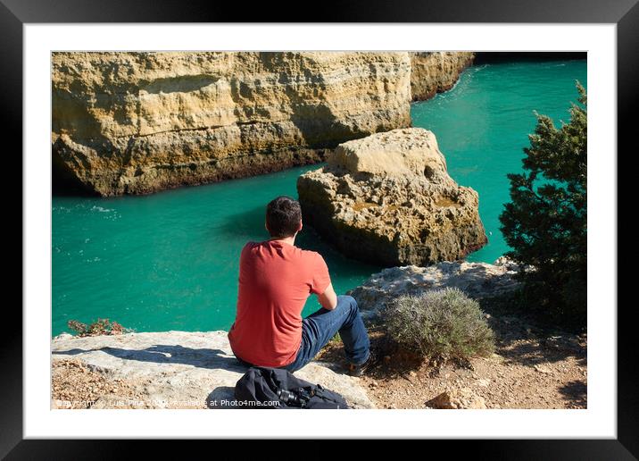 Man looking at a wild hidden secret beach with amazing turquoise water in Algarve, Portugal Framed Mounted Print by Luis Pina