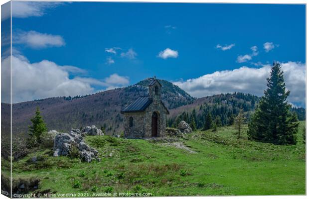 Stone chapel in mountains Canvas Print by Maria Vonotna