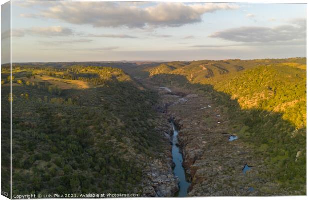 Pulo do Lobo waterfall drone aerial view with river guadiana and beautiful green valley landscape at sunset in Mertola Alentejo, Portugal Canvas Print by Luis Pina