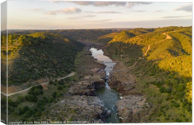 Pulo do Lobo waterfall drone aerial view with river guadiana and beautiful green valley landscape at sunset in Mertola Alentejo, Portugal Canvas Print by Luis Pina
