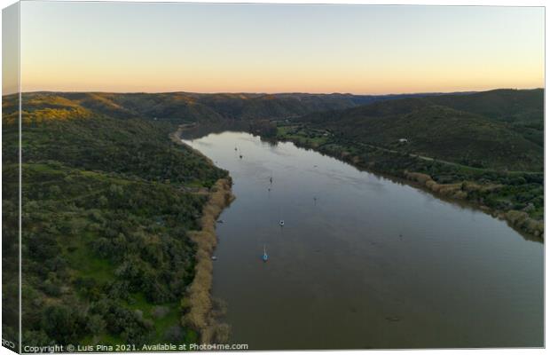 Aerial drone view of Sanlucar de Guadiana in Spain and Alcoutim in Portugal with sail boats on Guadiana river Canvas Print by Luis Pina