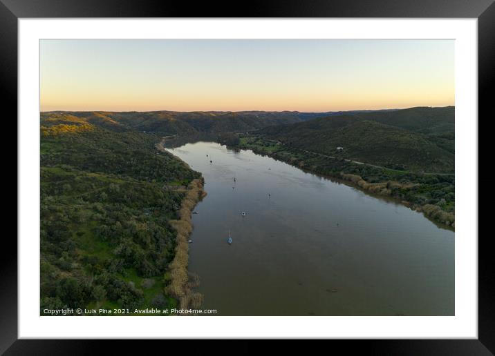 Aerial drone view of Sanlucar de Guadiana in Spain and Alcoutim in Portugal with sail boats on Guadiana river Framed Mounted Print by Luis Pina