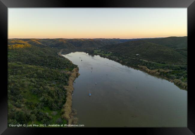 Aerial drone view of Sanlucar de Guadiana in Spain and Alcoutim in Portugal with sail boats on Guadiana river Framed Print by Luis Pina