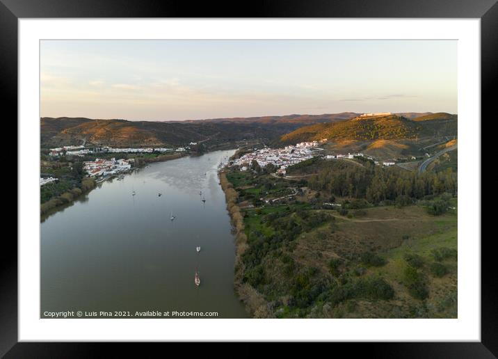 Aerial drone view of Sanlucar de Guadiana in Spain and Alcoutim in Portugal with sail boats on Guadiana river Framed Mounted Print by Luis Pina
