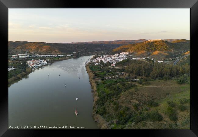 Aerial drone view of Sanlucar de Guadiana in Spain and Alcoutim in Portugal with sail boats on Guadiana river Framed Print by Luis Pina