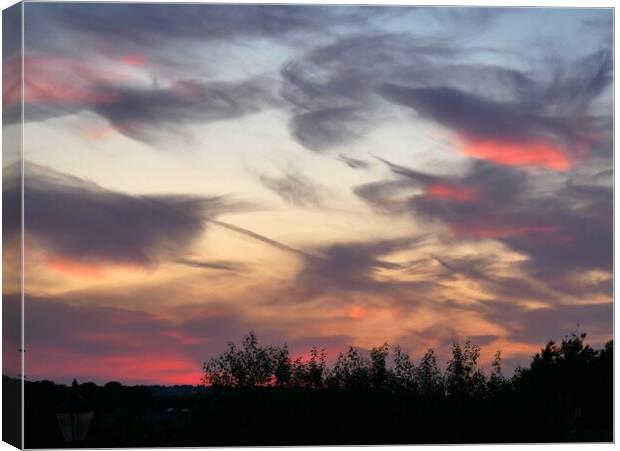 Swirly dramatic sunset  Canvas Print by Roy Hinchliffe
