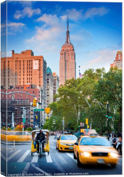 The Empire State Building from Broadway, New York Canvas Print by Justin Foulkes