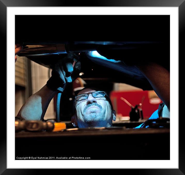 Mechanic soldering a muffler Framed Mounted Print by Eyal Nahmias