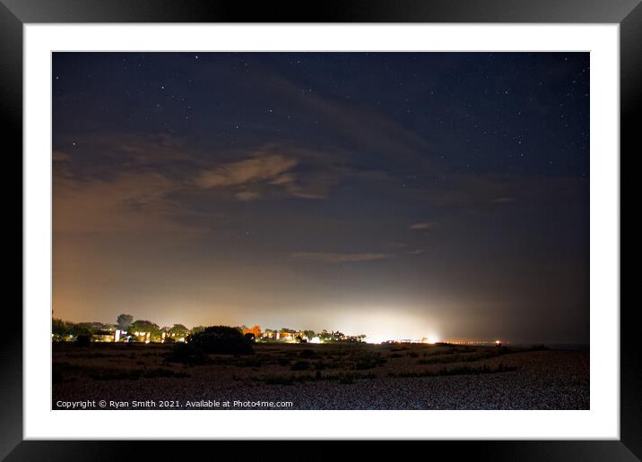 Coastal town under a starry sky Framed Mounted Print by Ryan Smith