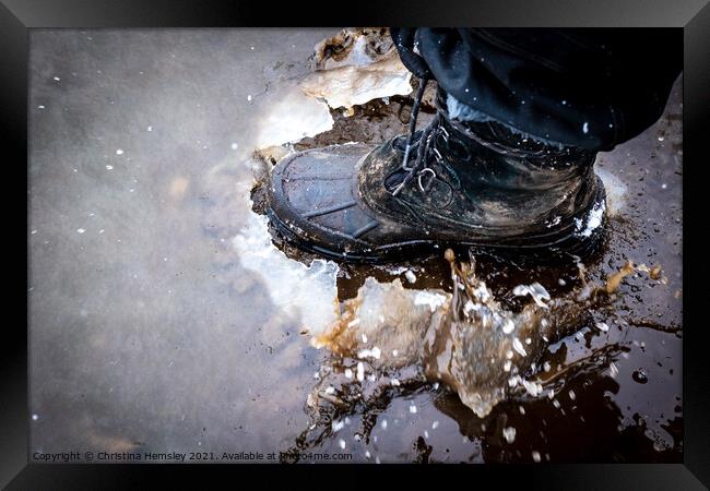 Boot cracking through an ice puddle Framed Print by Christina Hemsley