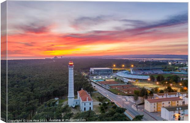 Aerial drone view of Vila Real de Santo Antonio city, lighthouse farol and stadium in Portugal, at sunset Canvas Print by Luis Pina