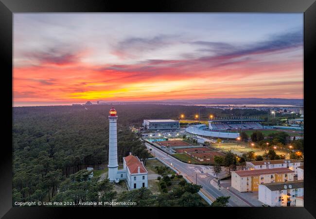 Aerial drone view of Vila Real de Santo Antonio city, lighthouse farol and stadium in Portugal, at sunset Framed Print by Luis Pina