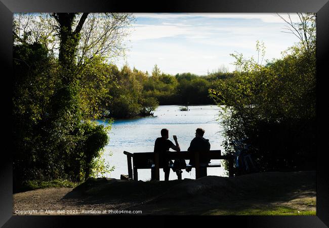 People Sitting by Lake Framed Print by Allan Bell