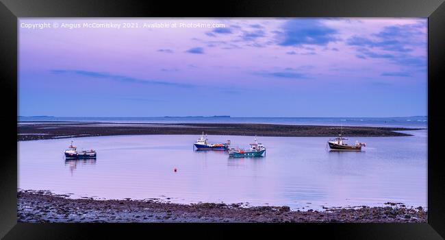 Fishing boats anchored at low tide, Holy Island Framed Print by Angus McComiskey