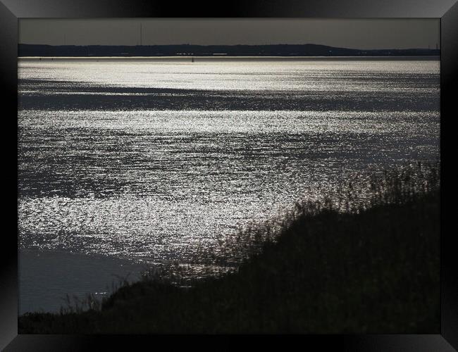 Sun setting over sea at Clevedon Somerset Framed Print by mark humpage