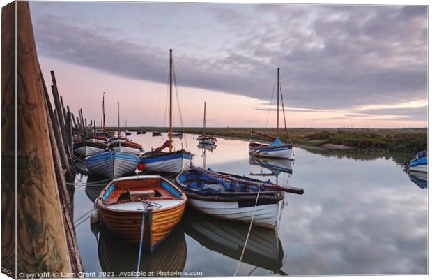Boats moored in Blakeney Harbour at dawn. Norfolk, UK. Canvas Print by Liam Grant