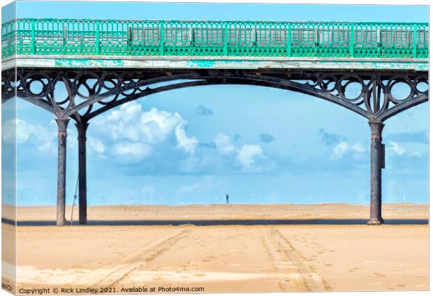 Walking Under Pier Canvas Print by Rick Lindley