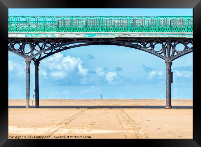 Walking Under Pier Framed Print by Rick Lindley